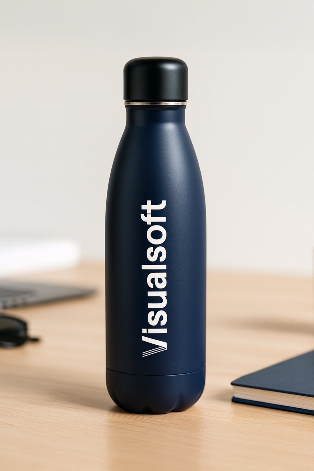 Dark blue water bottle with a black lid and the word "Visualsoft" printed vertically in white.