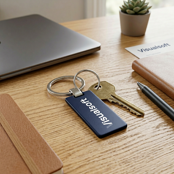 Visualsoft Store Branded Key Ring on a wooden desk with a laptop and notebook